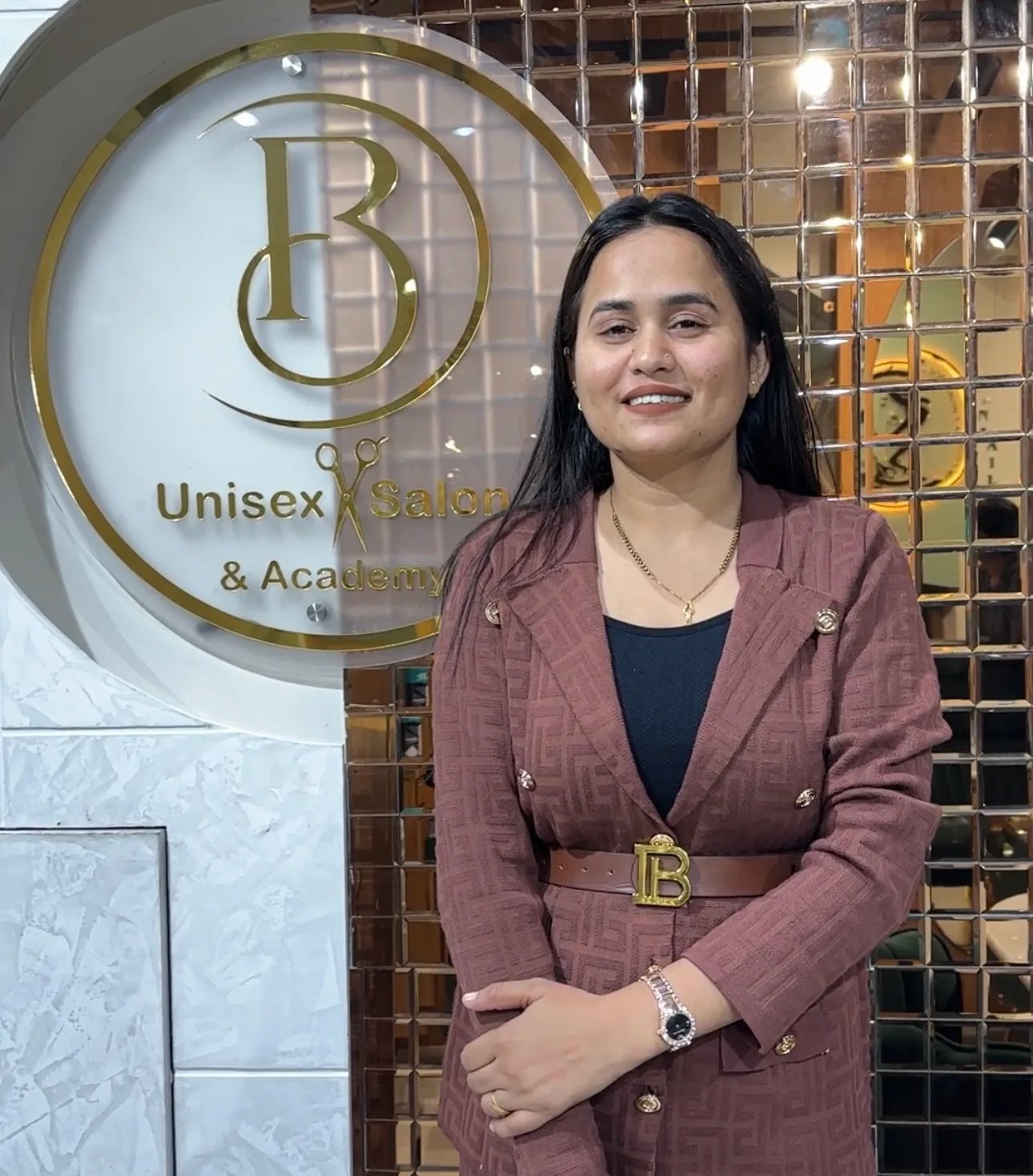 Babita at the salon's brand wall in Haldwani