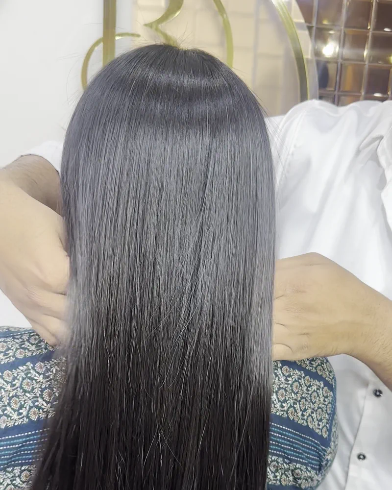 Long dark hair brushed smooth and held out straight from behind at Salon By Babita, Haldwani
