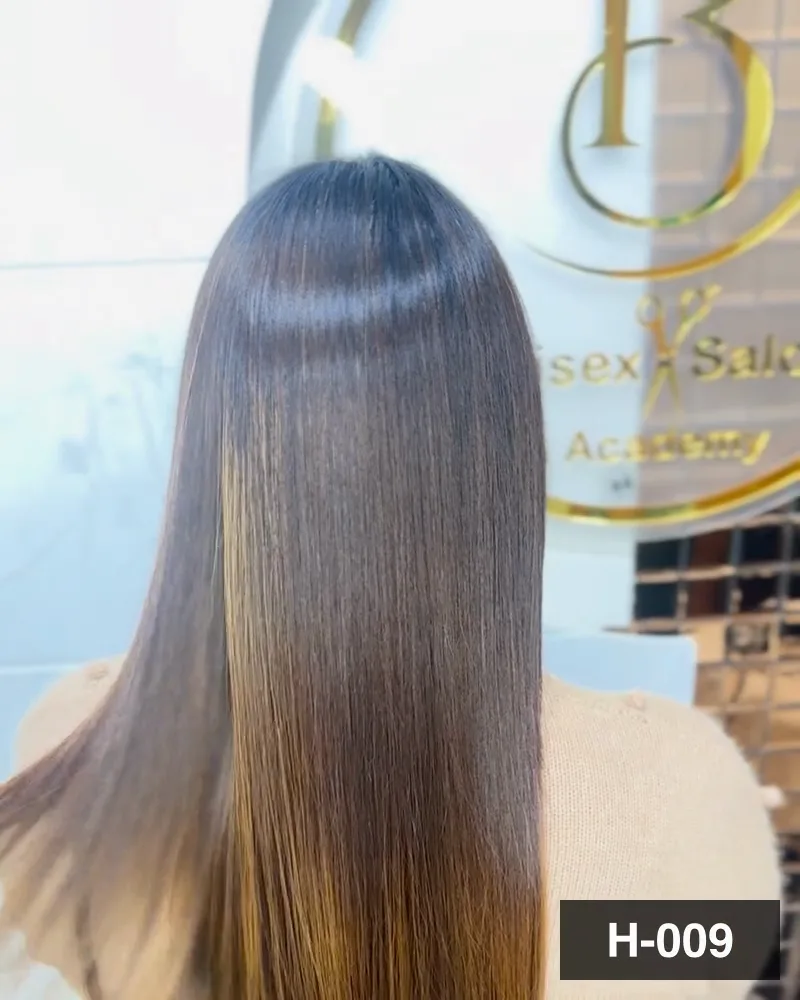 Long dark hair combed through to a glossy finish, seen from behind under the salon monogram at Salon By Babita, Haldwani — reference H-009