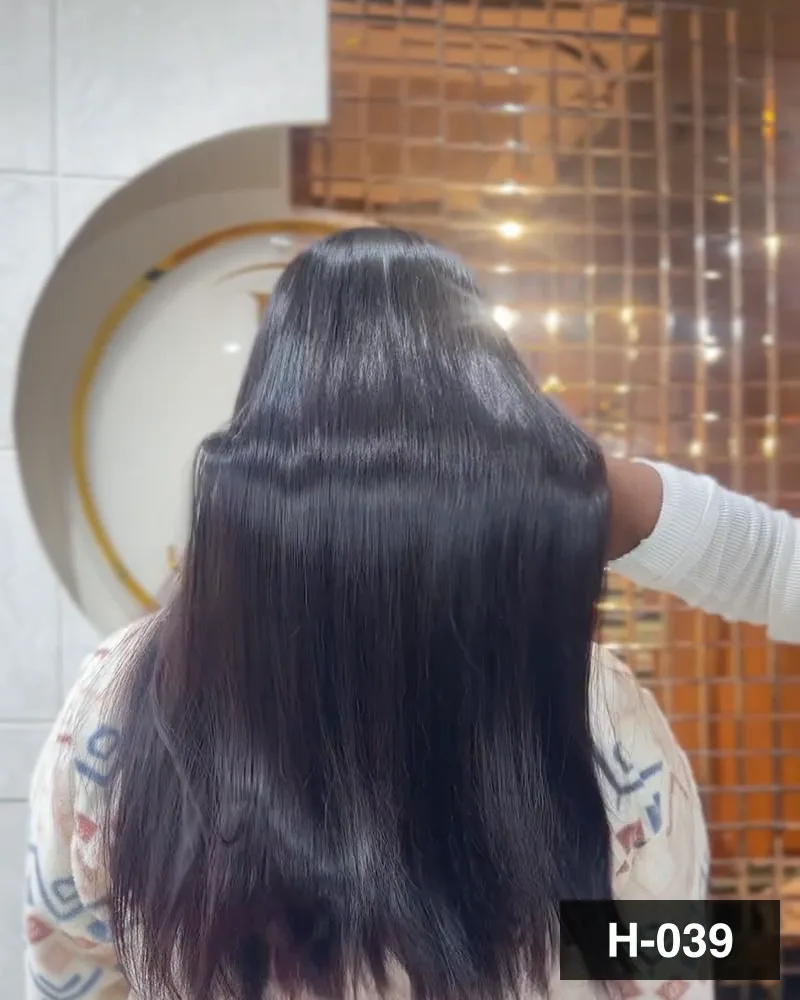 Long dark hair blow-dried with a soft wave, seen from behind at Salon By Babita, Haldwani — reference H-039