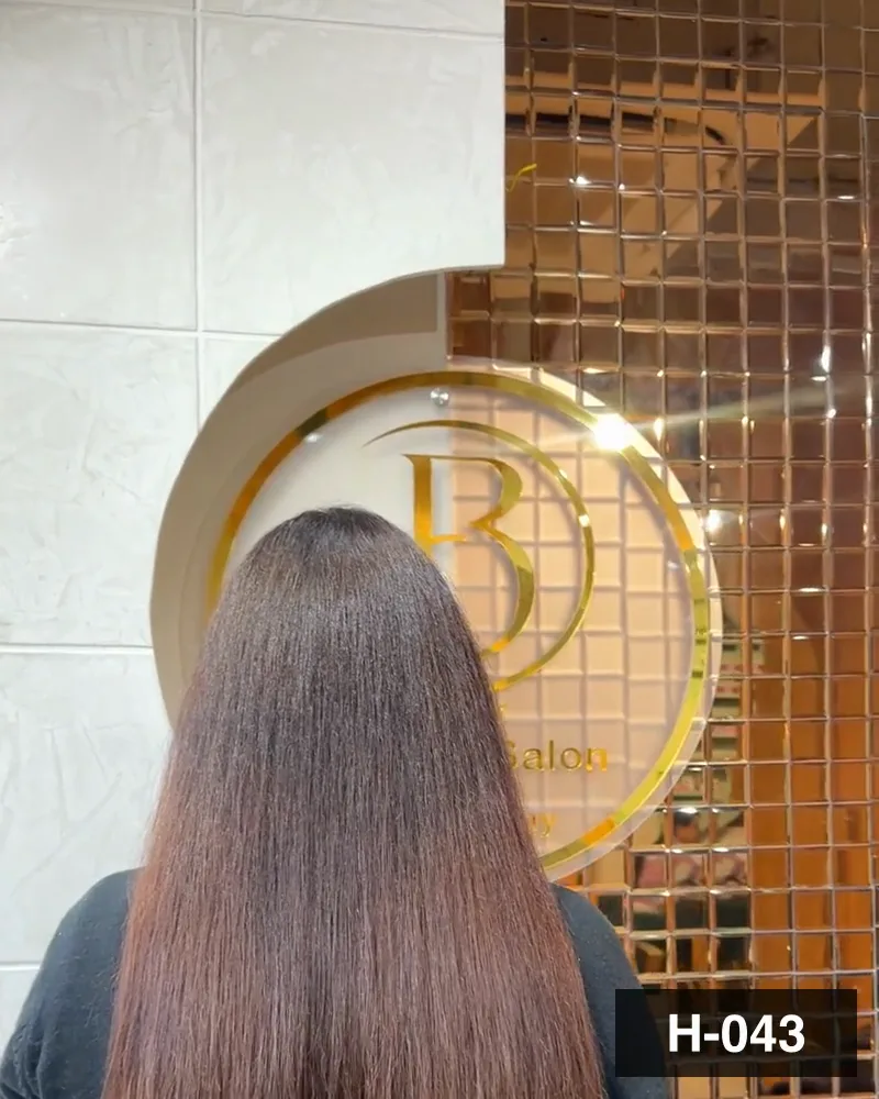 Cool brown hair cut to a blunt line at mid-length, seen from behind at Salon By Babita, Haldwani — reference H-043