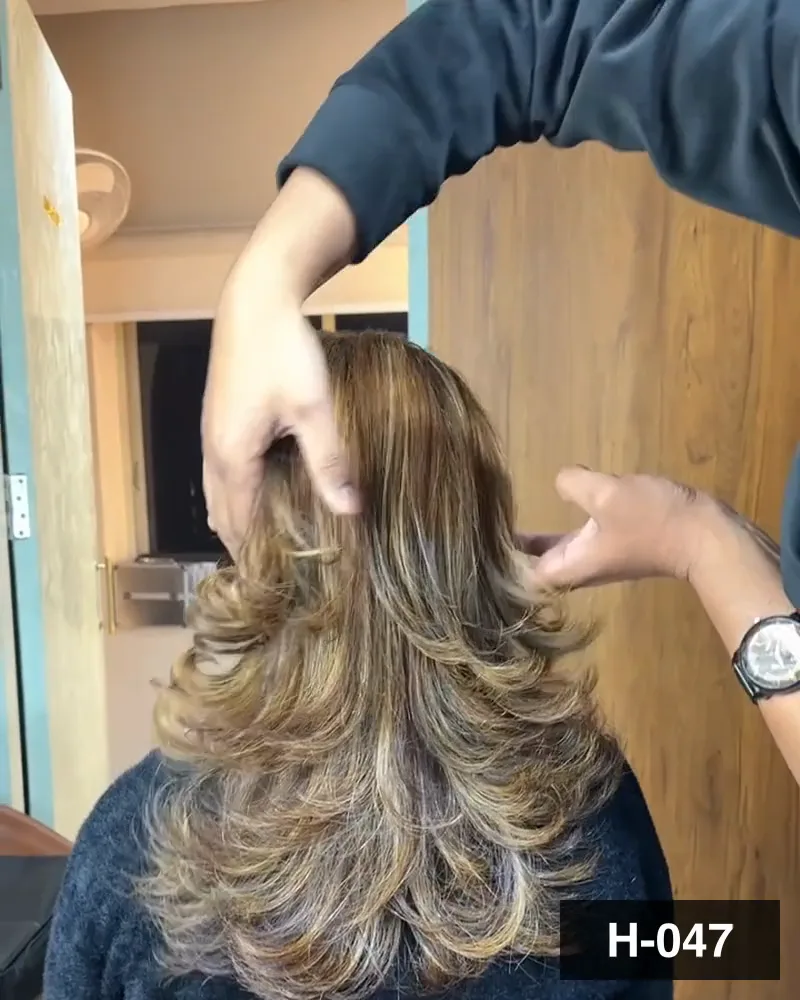 Layered hair lightened to caramel and blow-dried out to volume, seen from behind at Salon By Babita, Haldwani — reference H-047