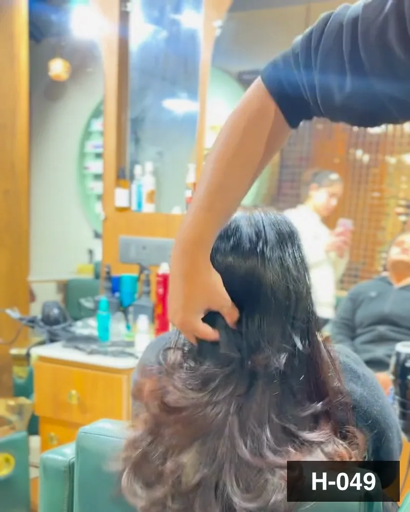 Long hair set into loose waves at the chair, seen from behind at Salon By Babita, Haldwani — reference H-049
