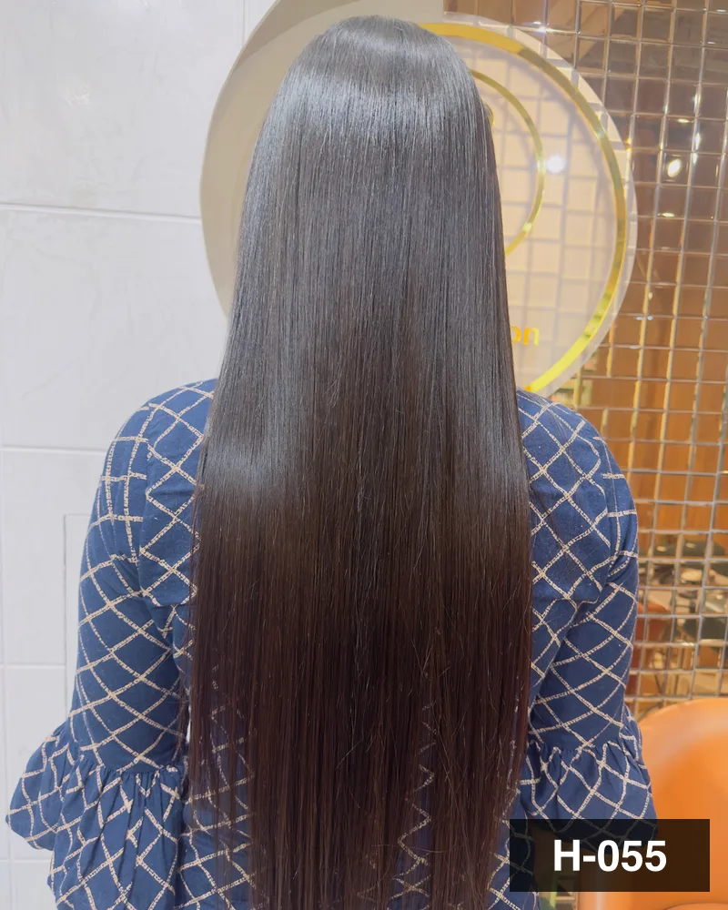 Waist-length dark brown hair combed straight and photographed from behind under the salon monogram at Salon By Babita, Haldwani — reference H-055