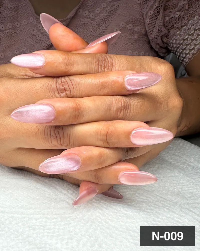 Long almond nail extensions in a pearl pink chrome finish at Salon By Babita, Haldwani — reference N-009