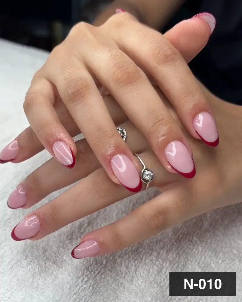 A red french tip almond nail set on both hands at Salon By Babita, Haldwani — reference N-010