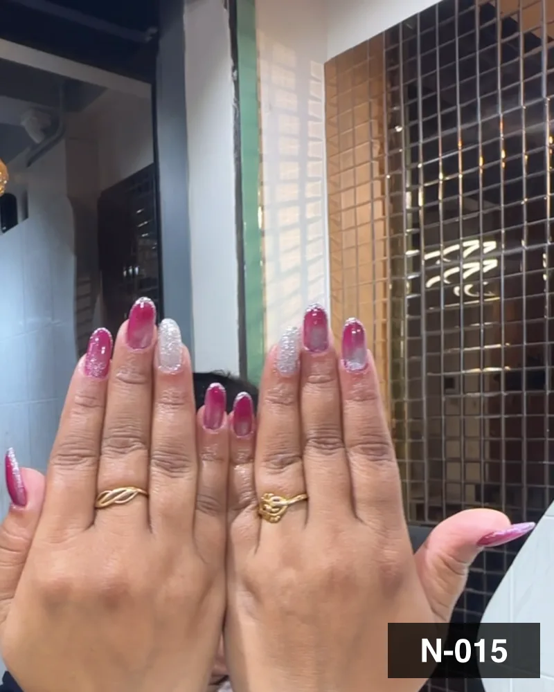 A red and pearl french almond set, both hands raised to show the full nail length at Salon By Babita, Haldwani — reference N-015