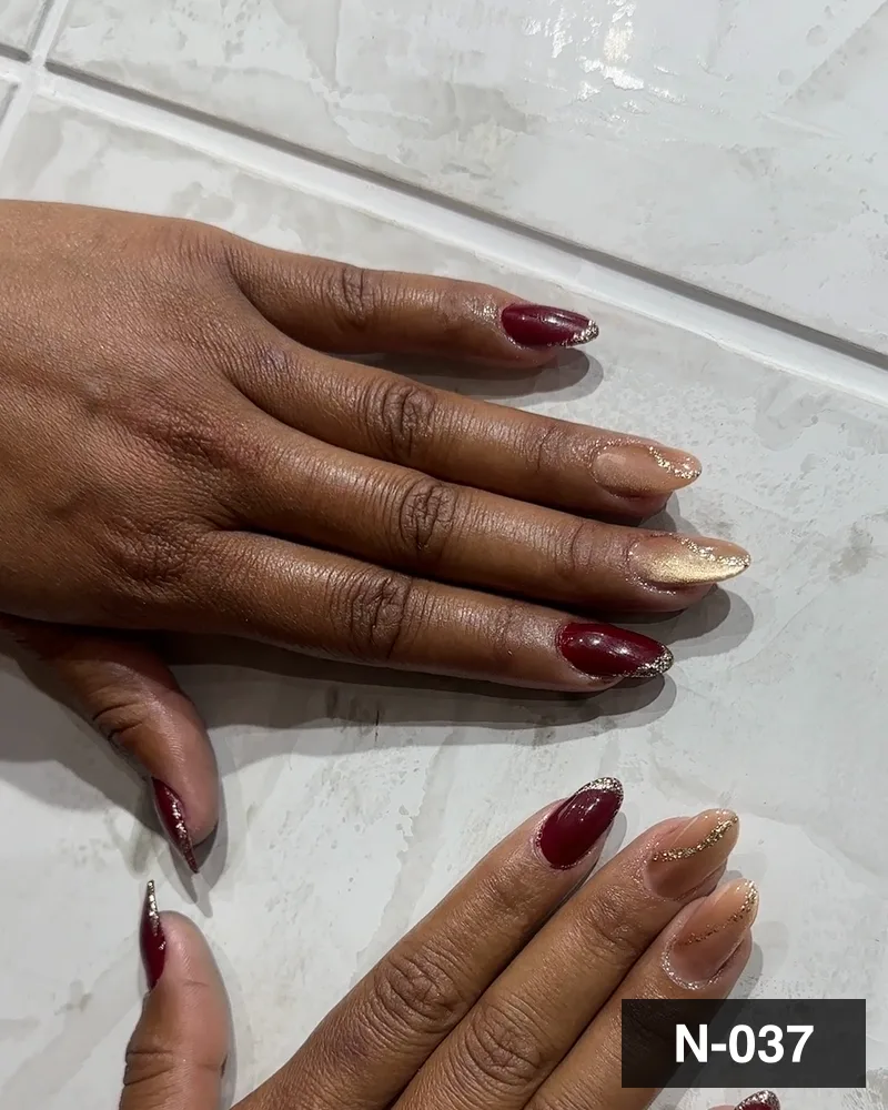 A wine almond set with a single gold glitter accent nail at Salon By Babita, Haldwani — reference N-037