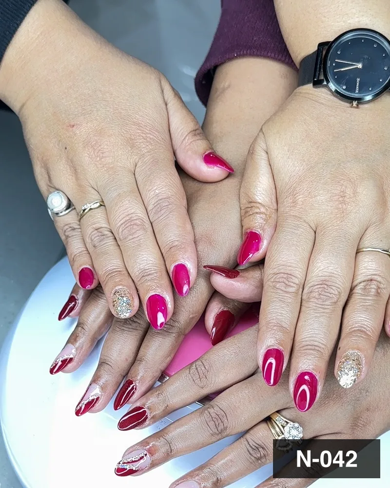 Red and magenta sets photographed together at the cure lamp at Salon By Babita, Haldwani — reference N-042