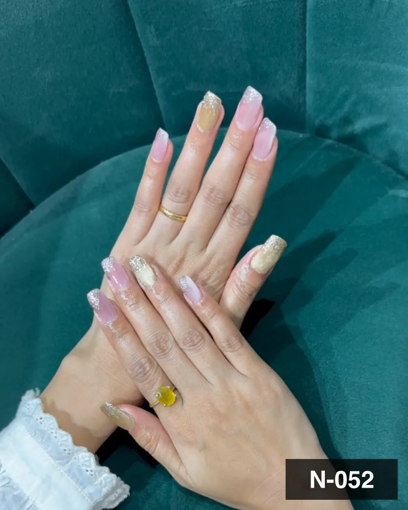 A nude ombré long almond set, photographed on the salon's velvet chair at Salon By Babita, Haldwani — reference N-052