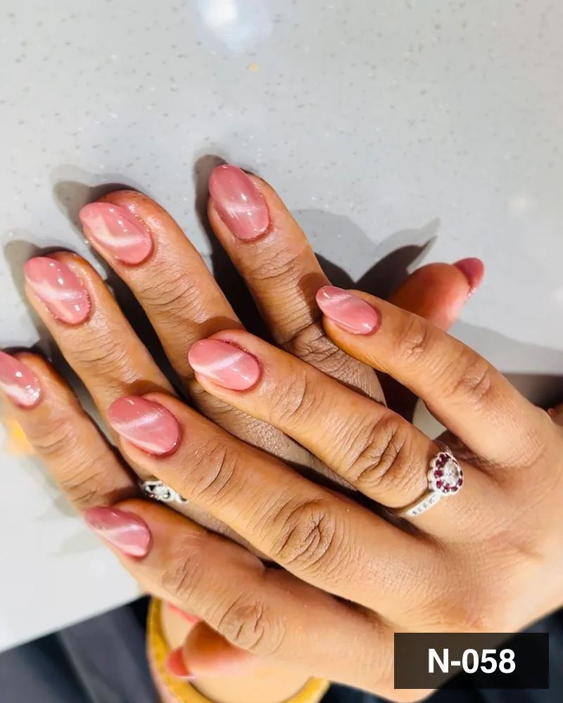 A peach and white swirl french almond set, both hands on the salon counter at Salon By Babita, Haldwani — reference N-058