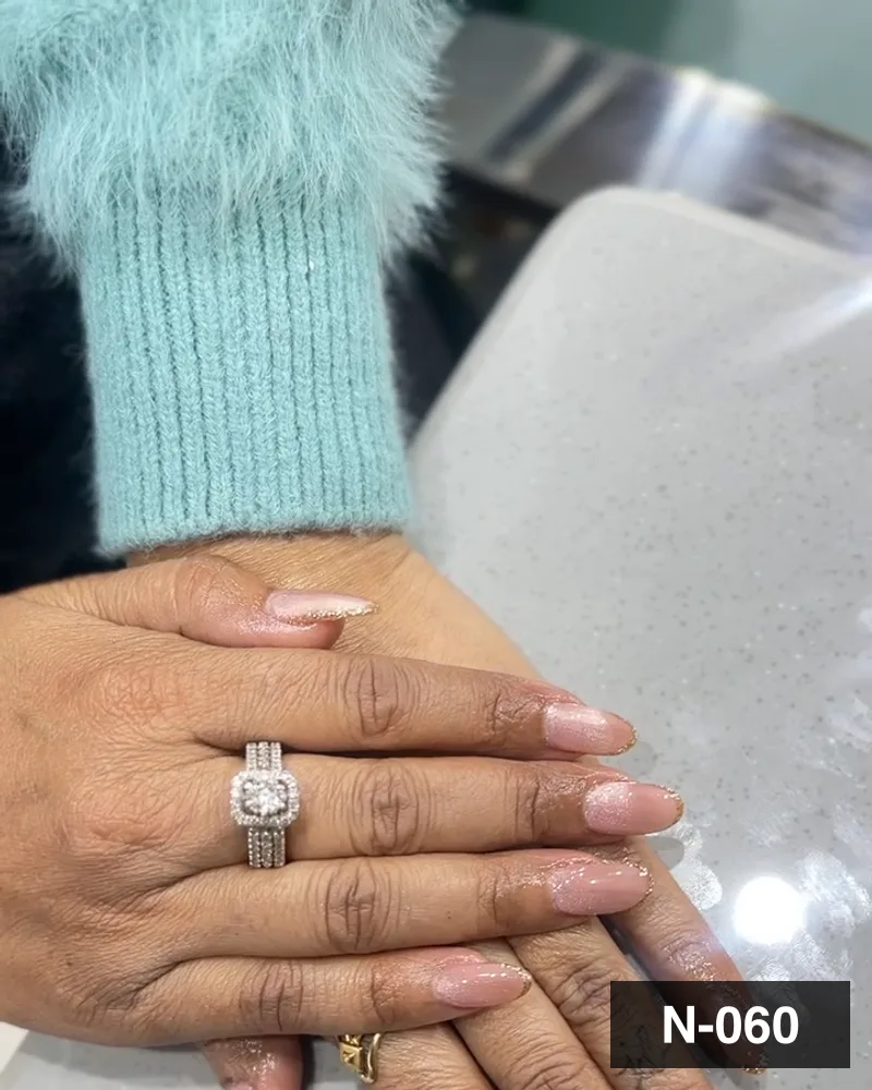 A nude almond set, both hands settled on the salon counter at Salon By Babita, Haldwani — reference N-060
