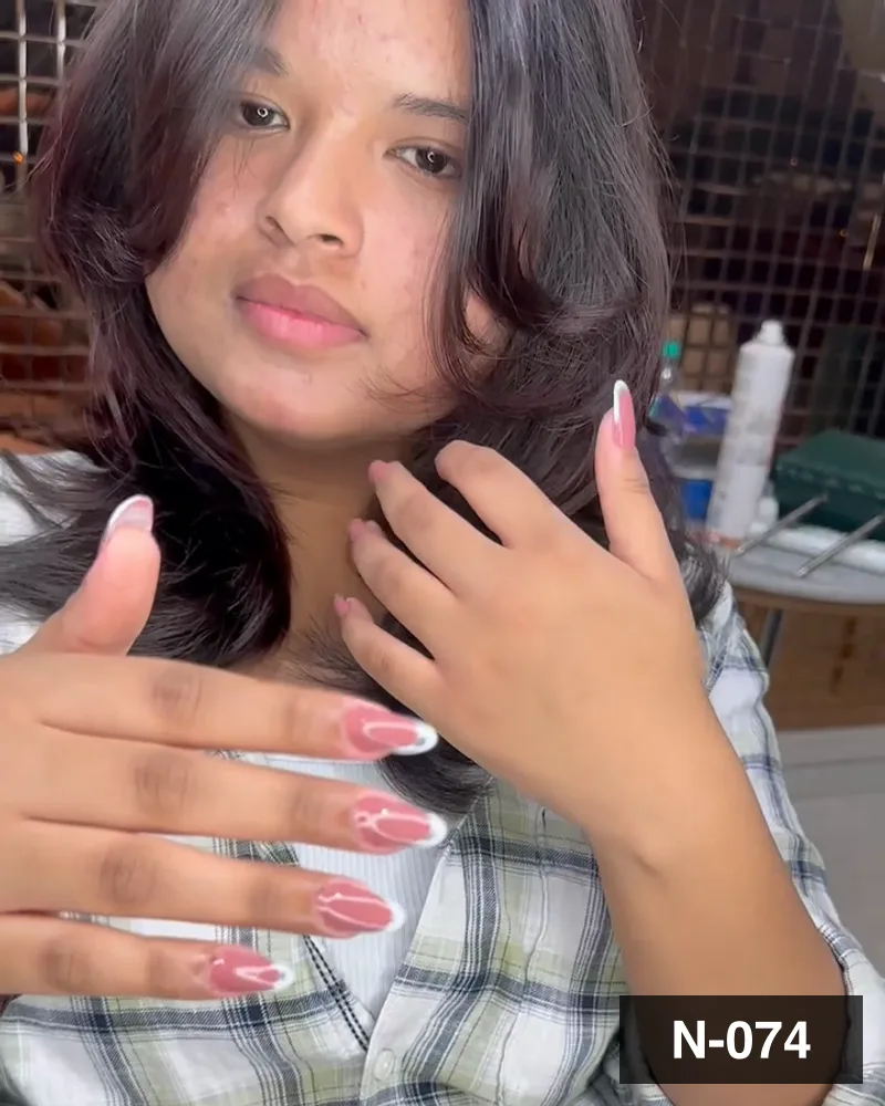 A nude french almond set, both hands raised by the guest in the salon at Salon By Babita, Haldwani — reference N-074