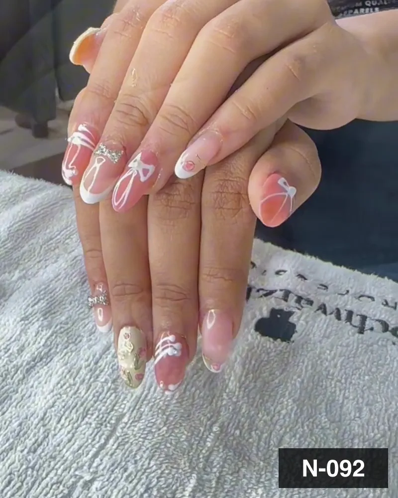 A pink and white french nail set with freehand bows and small floral work on both hands at Salon By Babita, Haldwani — reference N-092