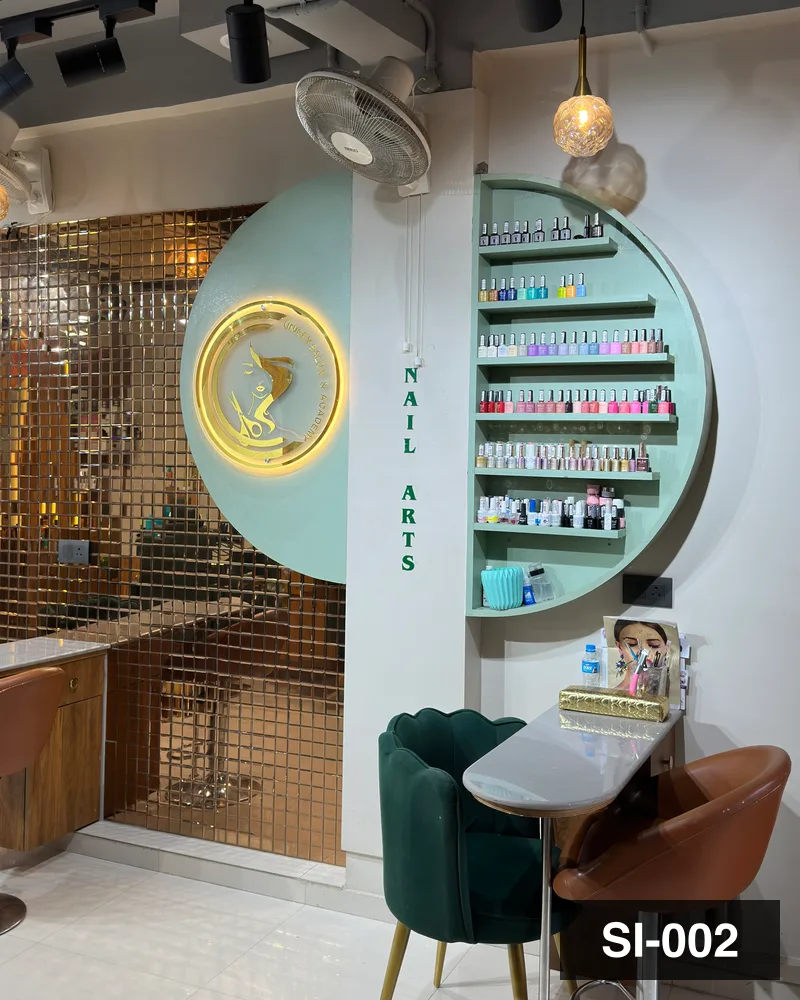 The manicure counter and polish shelves under the Nail Arts disc at Salon By Babita, Haldwani — reference SI-002