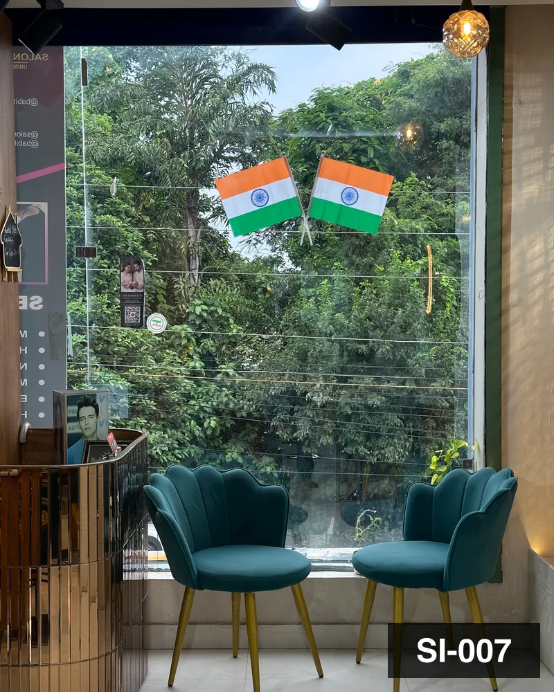 Two green velvet chairs at the first-floor window of Salon By Babita, Haldwani — reference SI-007