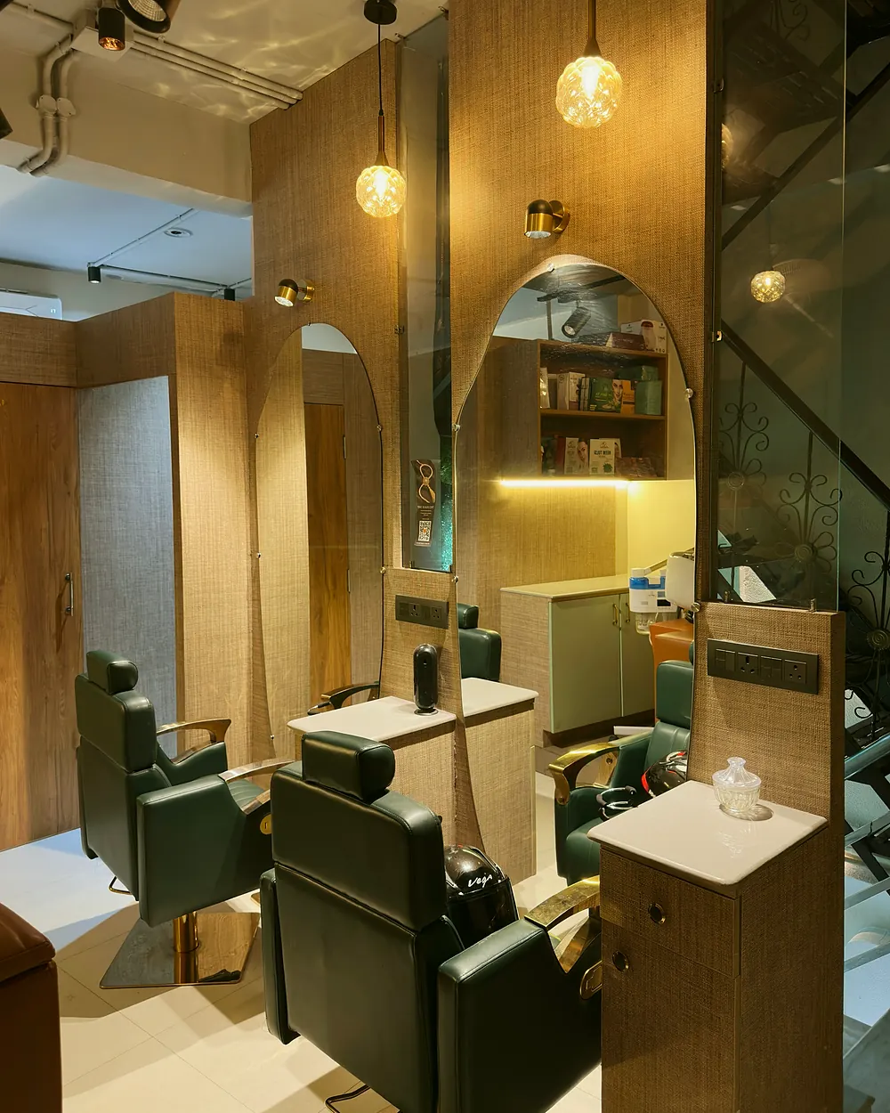 Styling stations with arched mirrors and jute panelling inside Salon By Babita, Haldwani