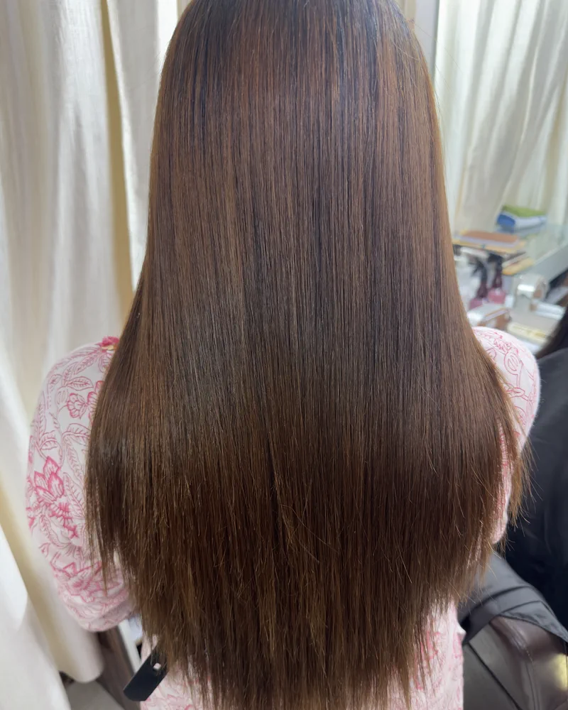 Long brown hair with a smooth, glossy finish, seen from behind at Salon By Babita, Haldwani