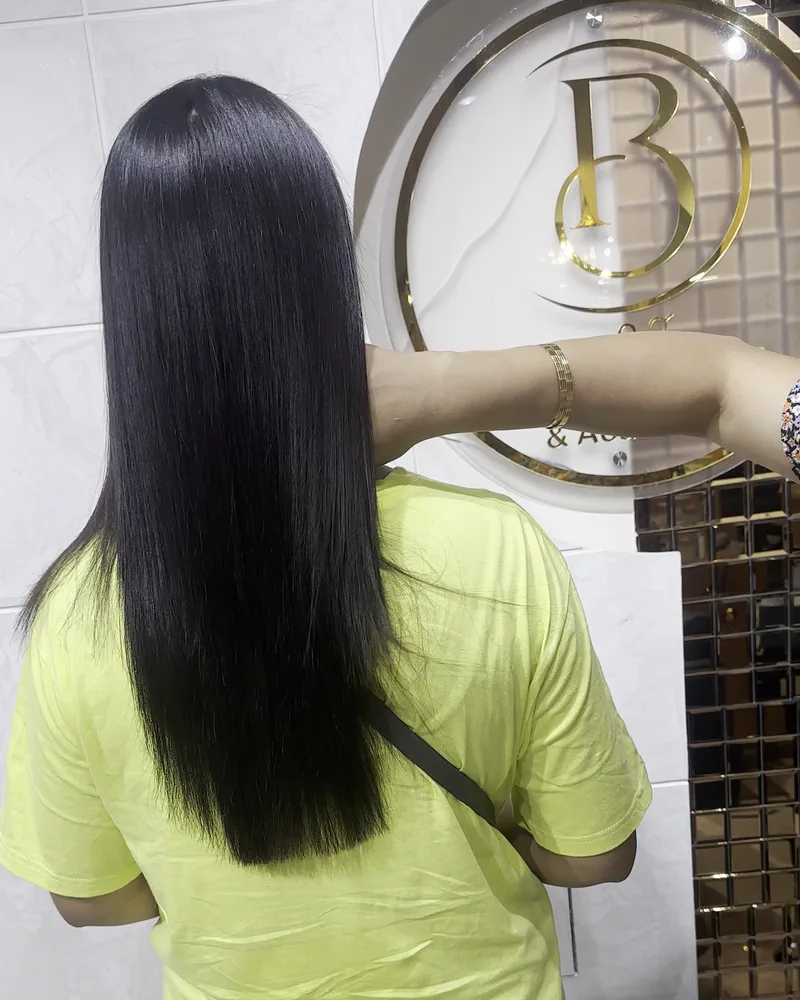 Sleek straight black hair falling to mid-back, seen from behind at Salon By Babita, Haldwani