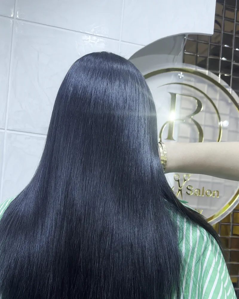 Long black hair brushed straight to a glossy finish, seen from behind at Salon By Babita, Haldwani
